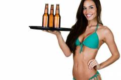 Sexy woman holding a serving tray of beer and wearing a bikini